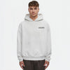 Sweat à capuche blanc cassé TOURISMO porté par un homme, fond blanc, style minimaliste