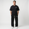 T-shirt noir oversize Tourismo Clothing porté en full look avec logo poitrine blanc